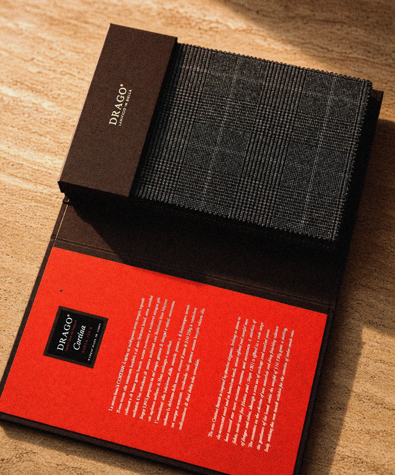 The Hajjo Tailoring cloth book on a leather folder